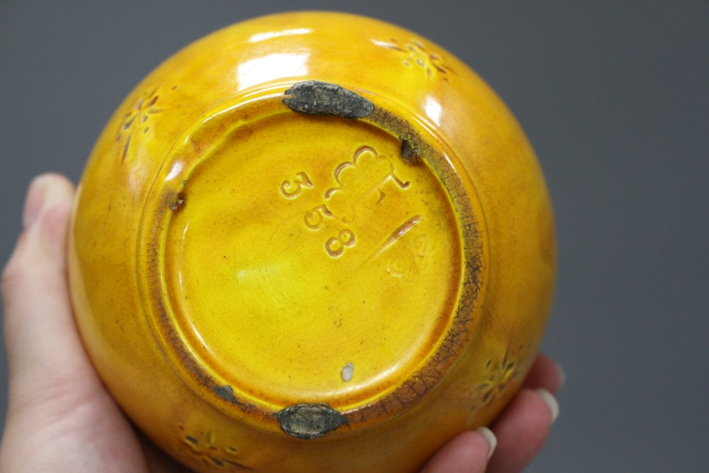 A Burmantofts yellow glazed vase, with impressed stylised floral decoration, monogrammed and numbered 358, height 23cm
